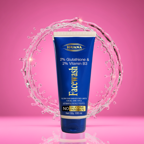 Iguana Facewash tube with water droplets on a pink background